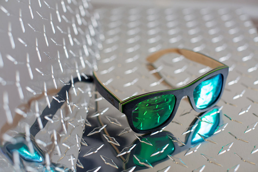 Black Skateboard Wood with Green Side Details and Reflective Green Polarized Lenses